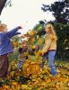 Young-Girl-and-Her-Two-Brothers-Throwing-Autumn-Leaves.jpg