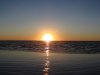 blazing sunrise water wet sand small.JPG