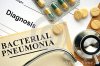 bacterial-pneumonia-word-book-pills-wooden-table-57689058.jpg